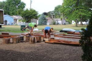 A picture of FCMA staff organizing and assembling the new jungle gym on FCMA's campus