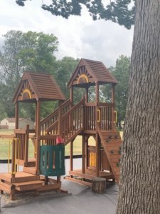 Picture of the big wooden jungle Gym as it rests now on FCMA's Campus