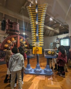 Four Corners Montessori Academy students enjoying an exhibit at the Henry Ford Historical Museum that explains power to young scholars.